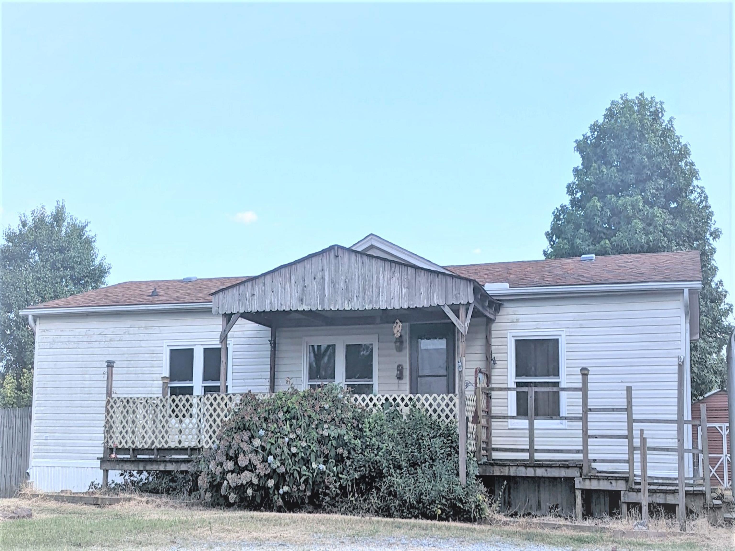 a view of a house with a backyard