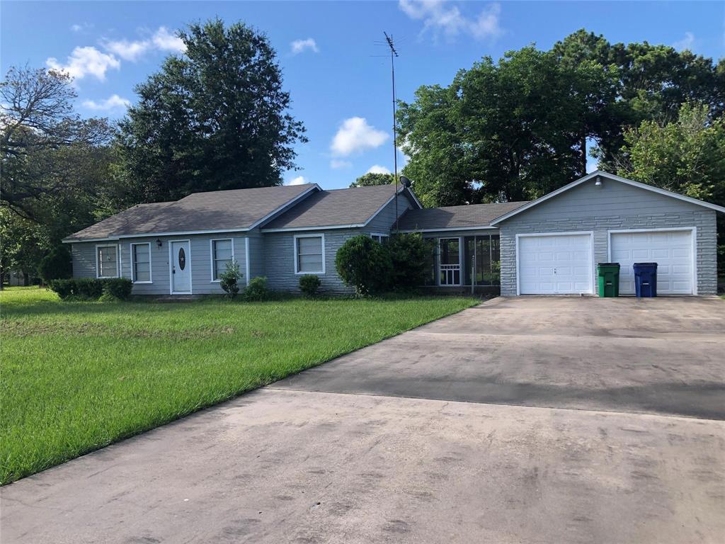 a house with green field in front of it