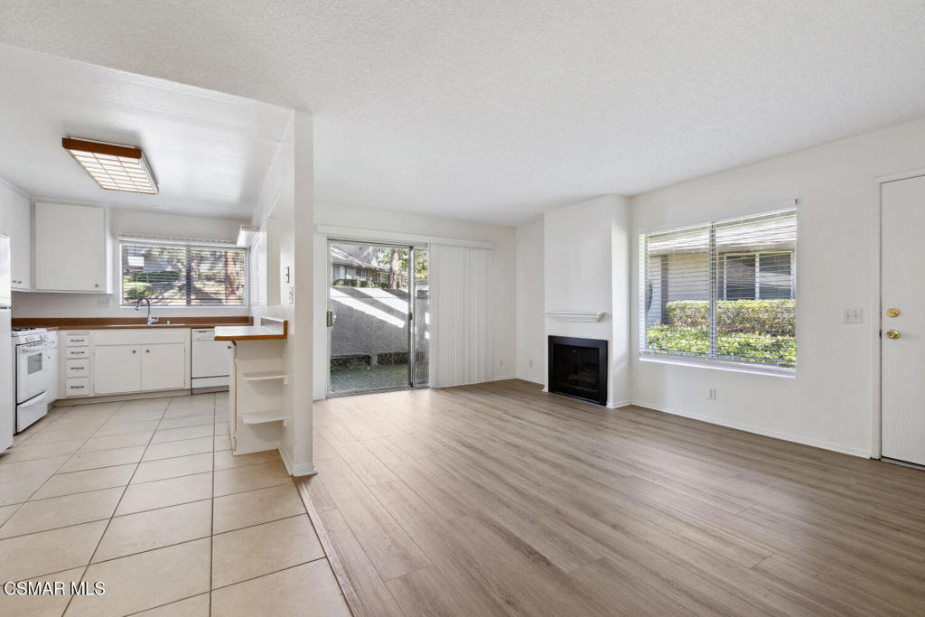 a view of a kitchen with furniture and a floor to ceiling window