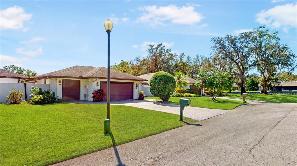 a view of a house with a yard and tree s