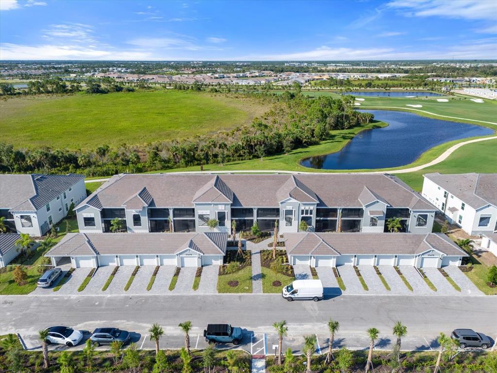 an aerial view of residential houses with outdoor space and ocean view