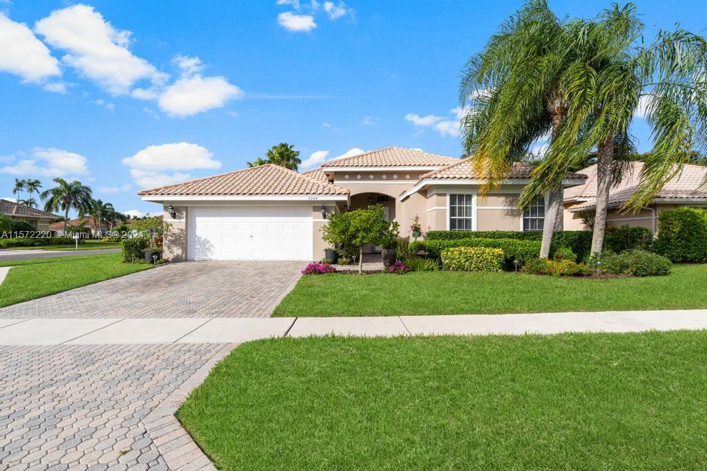 a front view of a house with a garden