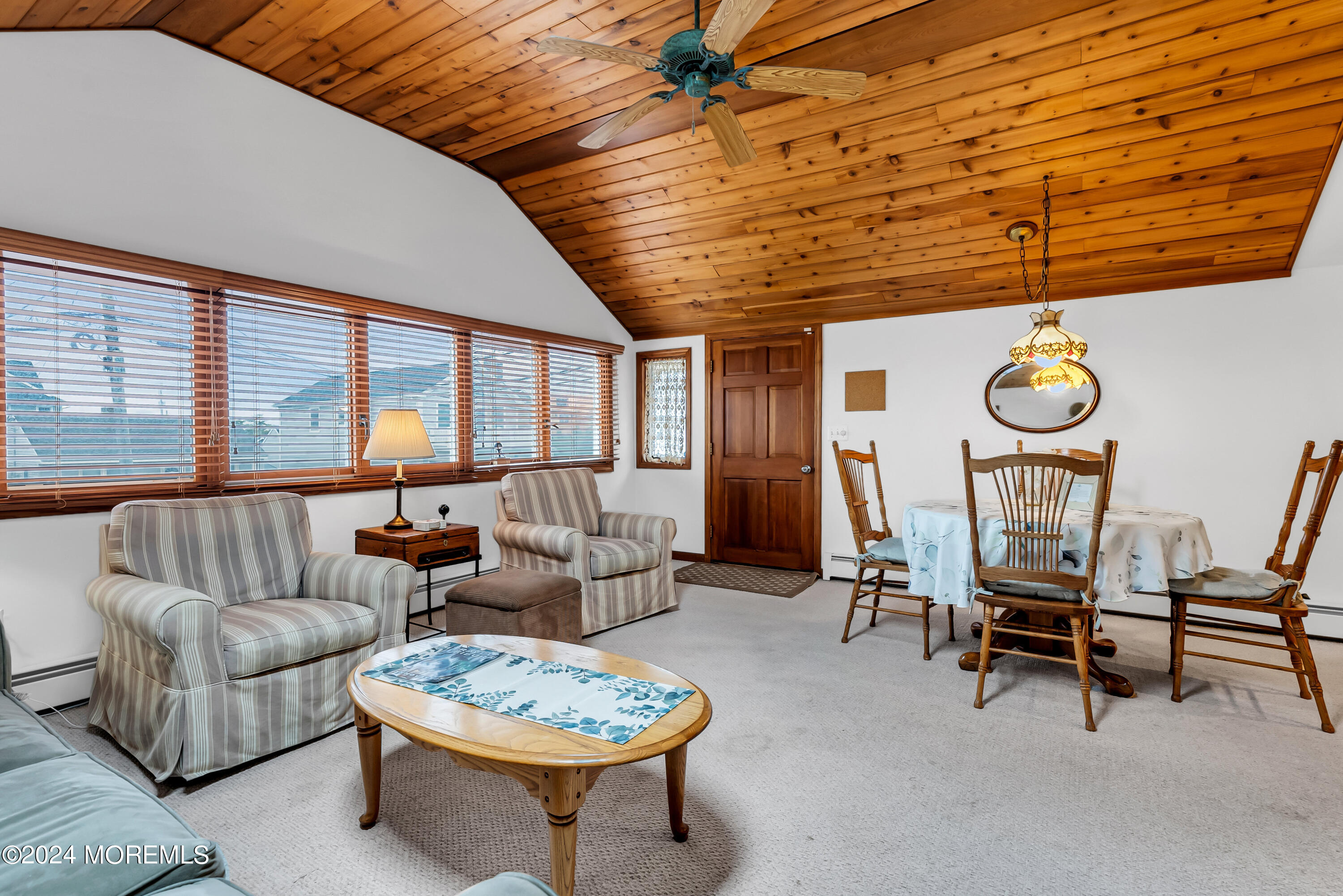 a living room with furniture a rug and a large window