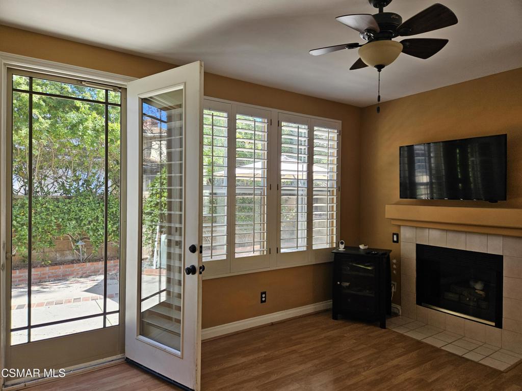 a view of an empty room with a fireplace and a window