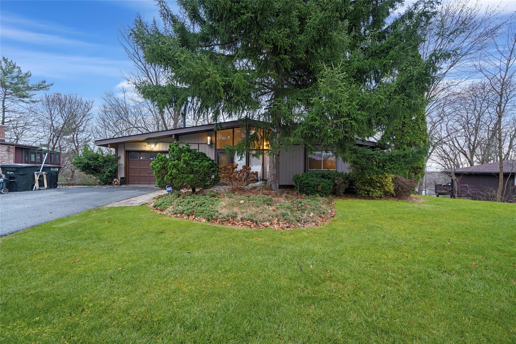 View of front of property featuring a front yard and a garage