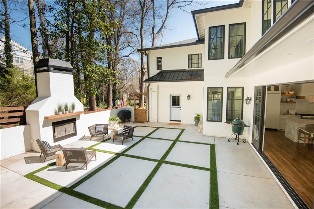 a view of a patio with couches table and chairs and potted plants