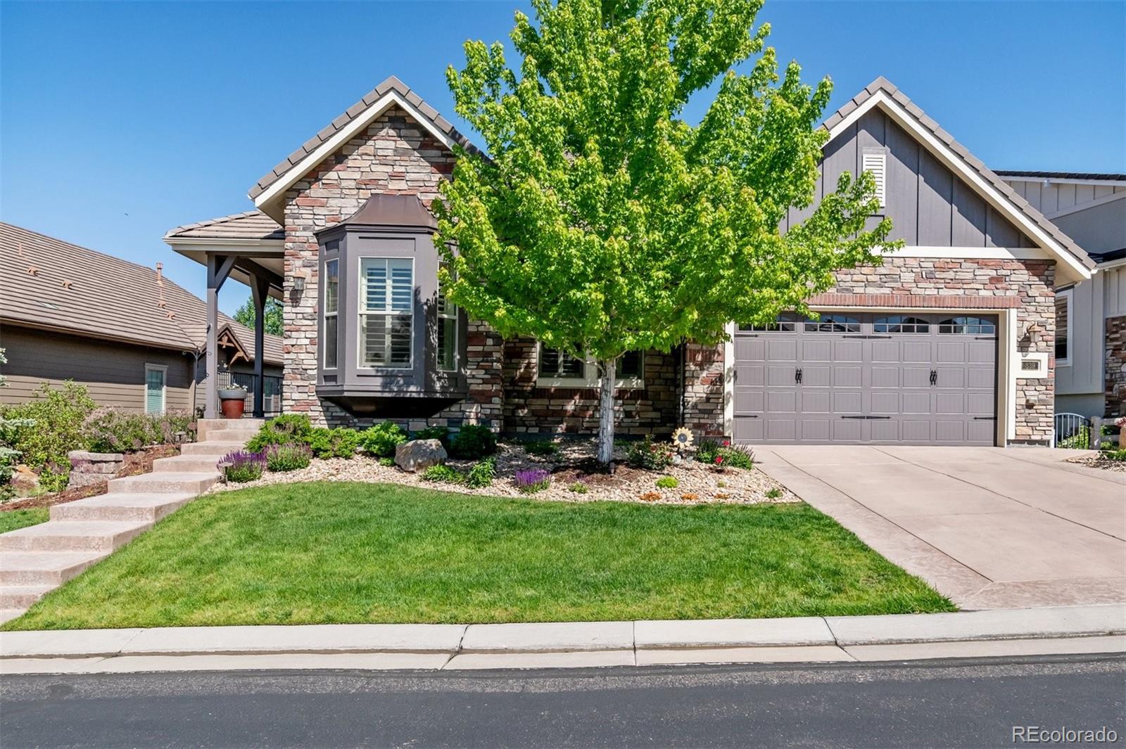 a front view of a house with a yard and garage