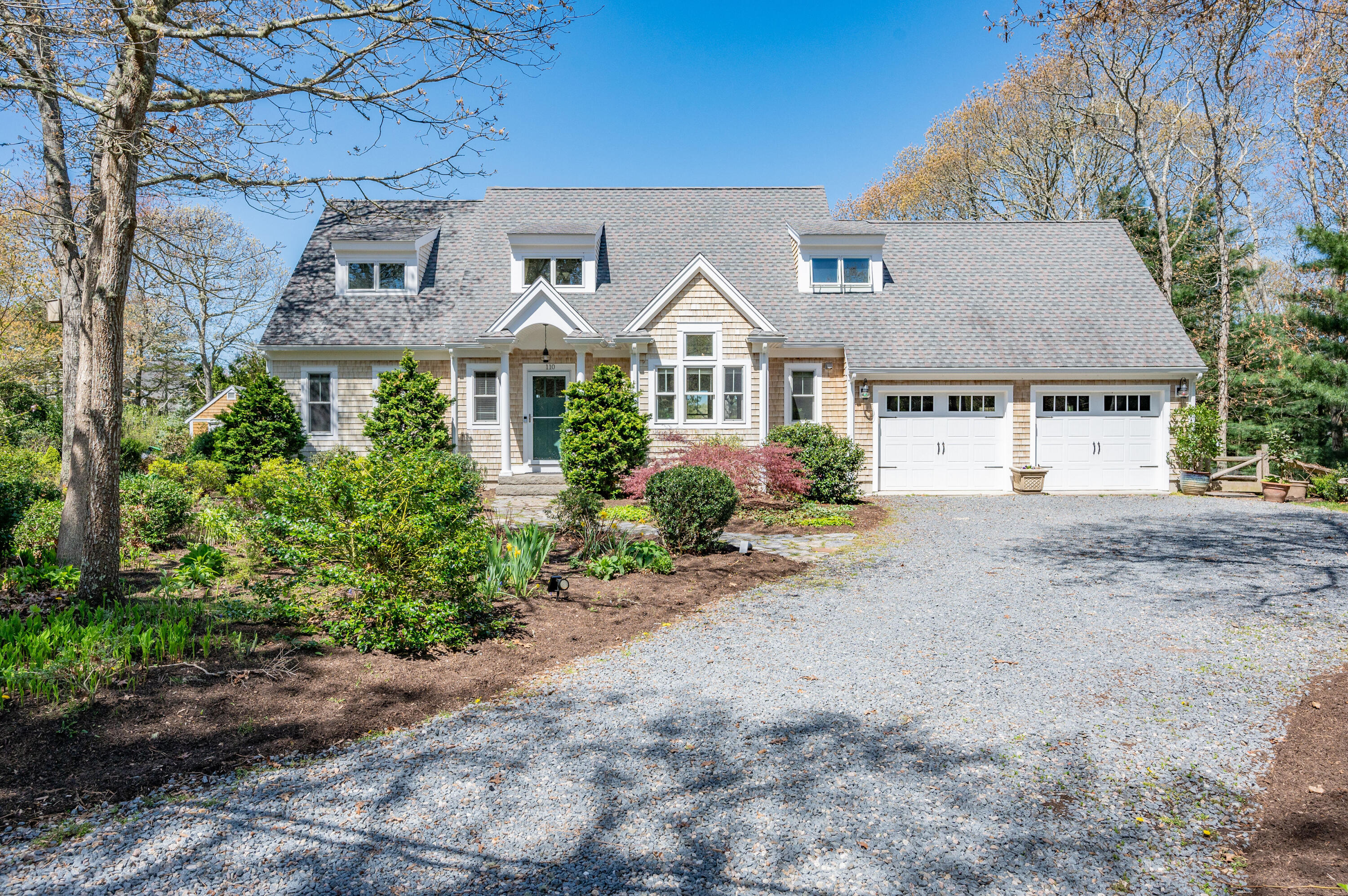 a front view of a house with a garden