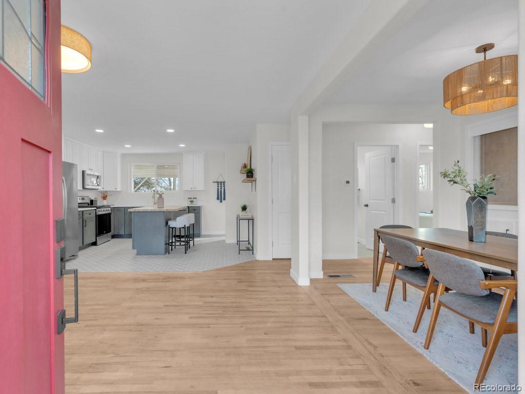 a dining room with furniture and a kitchen view