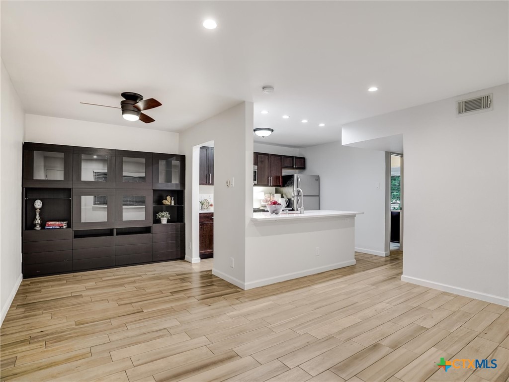 a view of kitchen with refrigerator and window