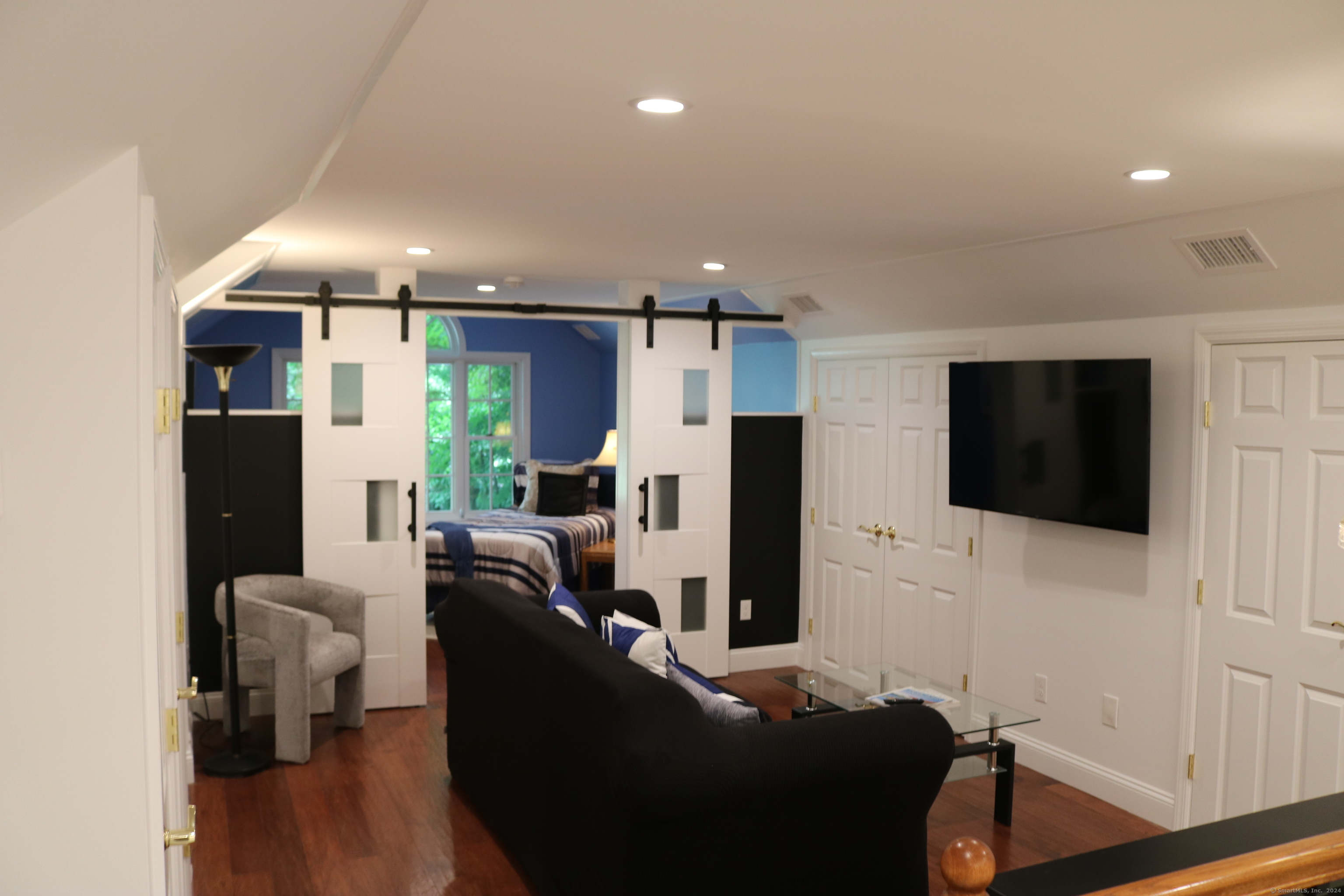 a living room with furniture and a flat screen tv