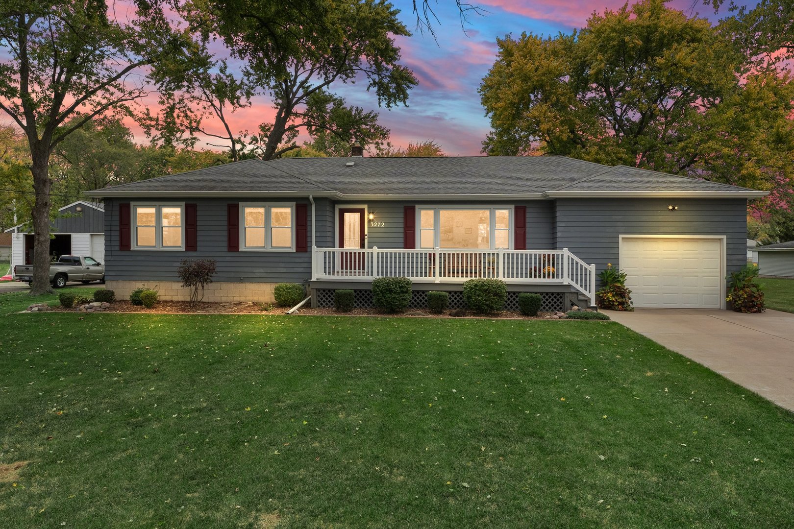 a front view of a house with a garden and plants