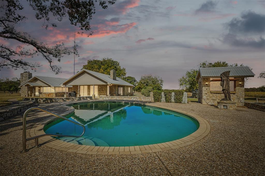 a view of a house with swimming pool and sitting area