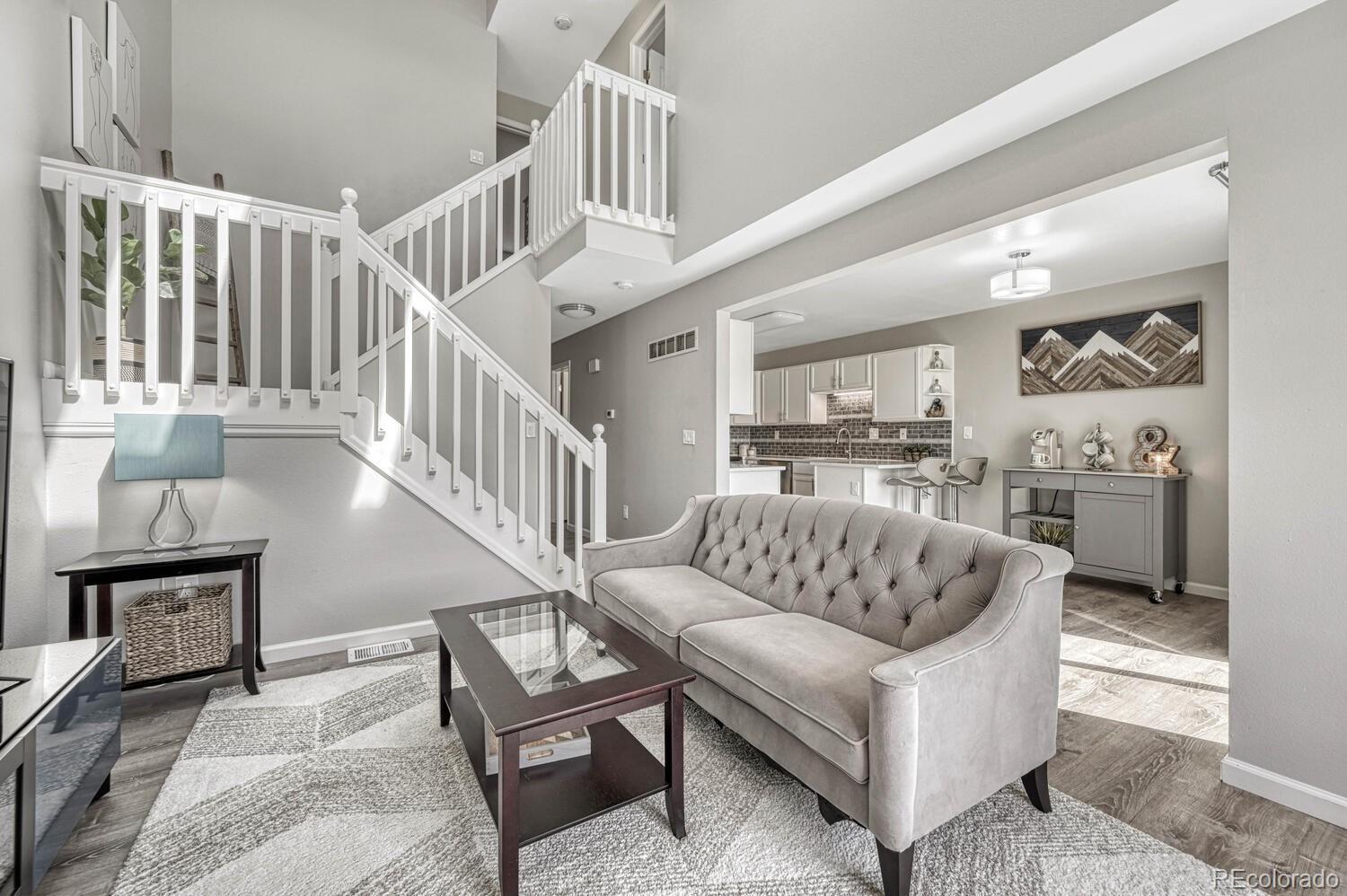 a living room with furniture and a dining table