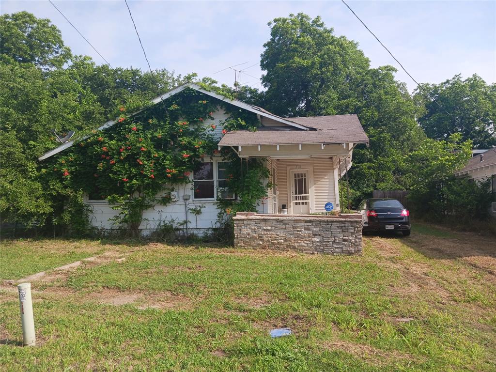 a view of a house with a yard and sitting area