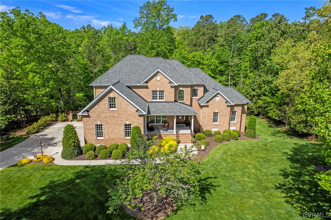 a front view of a house with a yard and trees