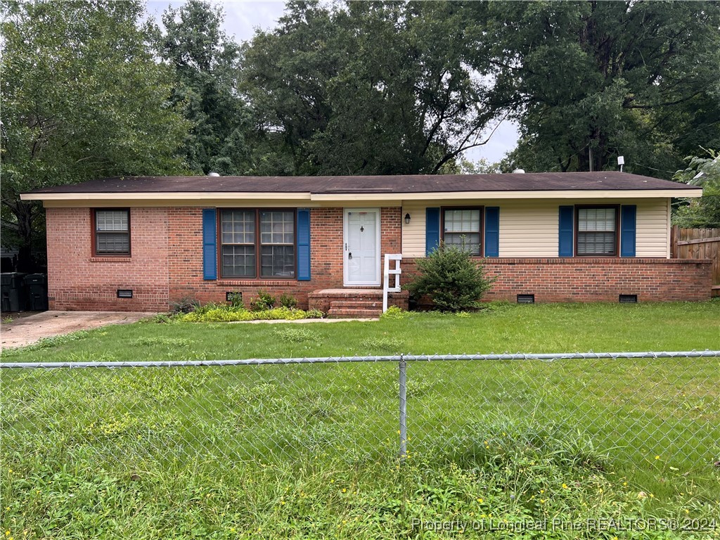 a front view of house with yard and trees