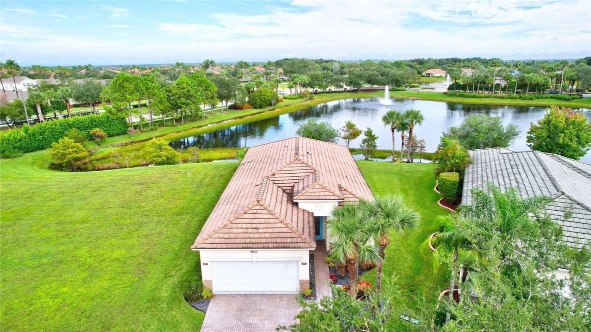 a view of a lake with a yard and large trees