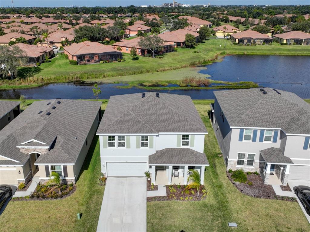 an aerial view of a house with outdoor space and lake view