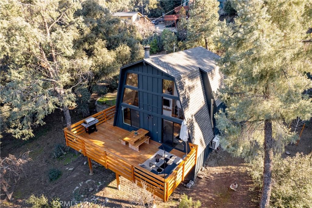 an aerial view of a house with a yard