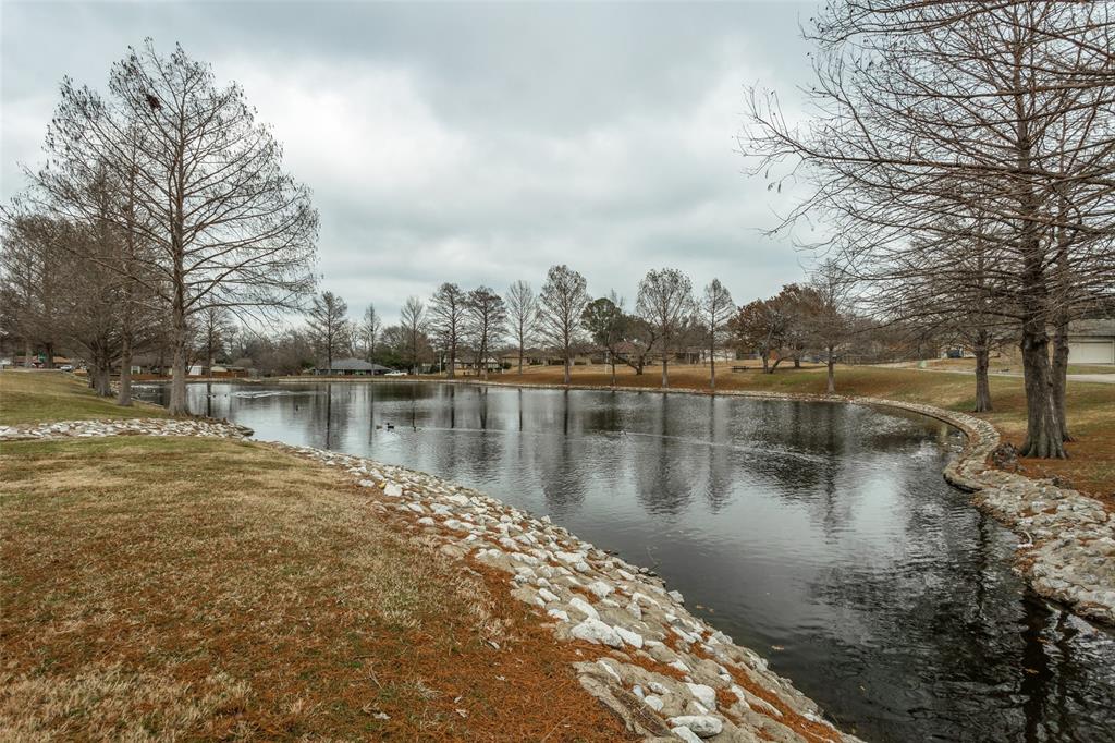 a view of a lake with houses in the back