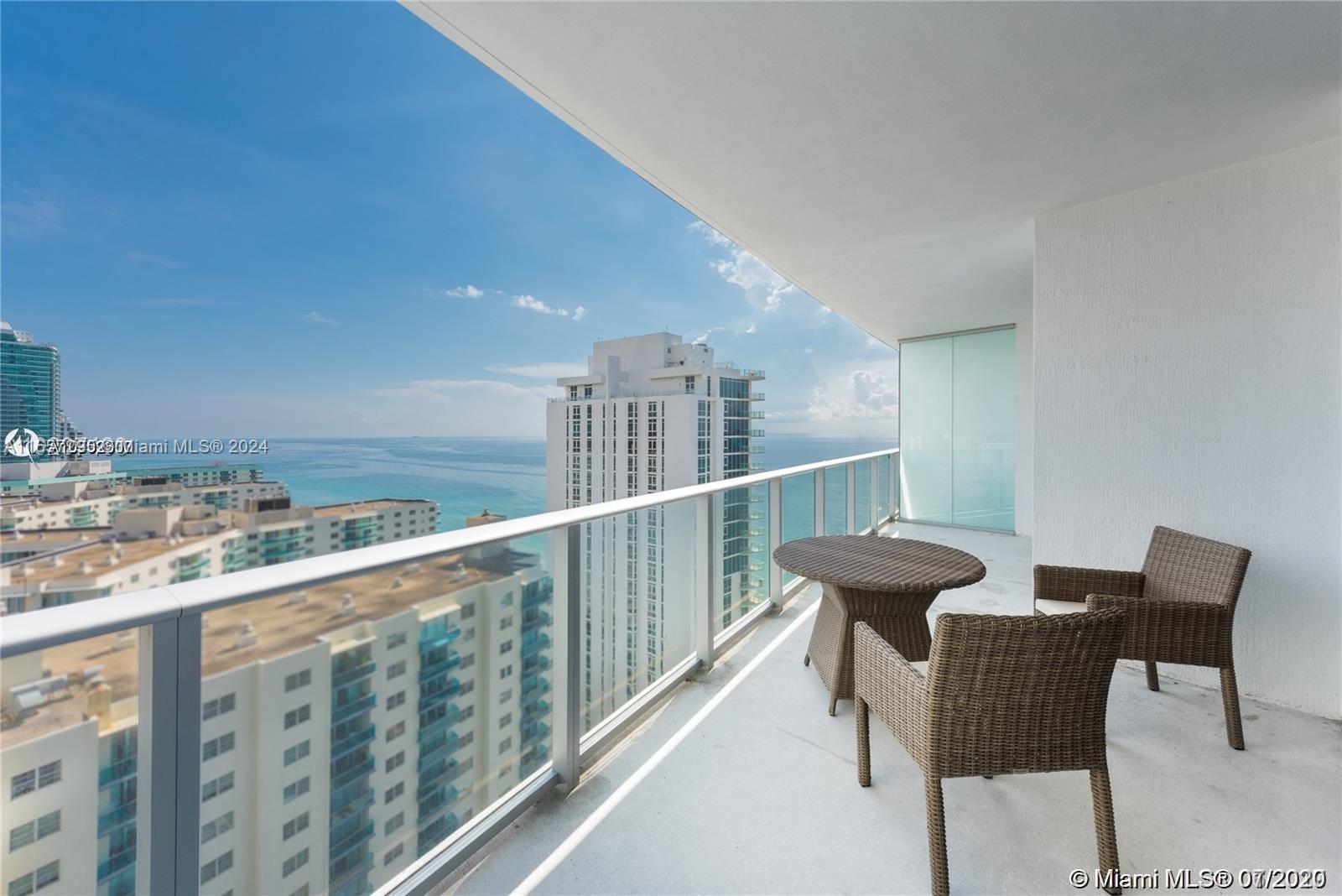 a view of a chairs and table in the balcony