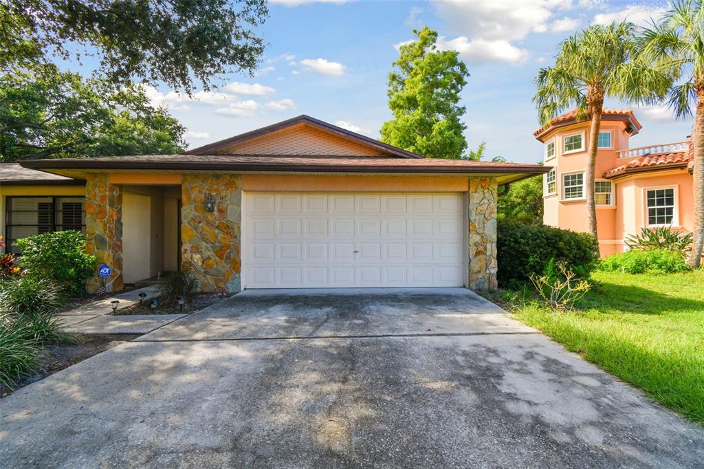 a front view of a house with a yard and a garage