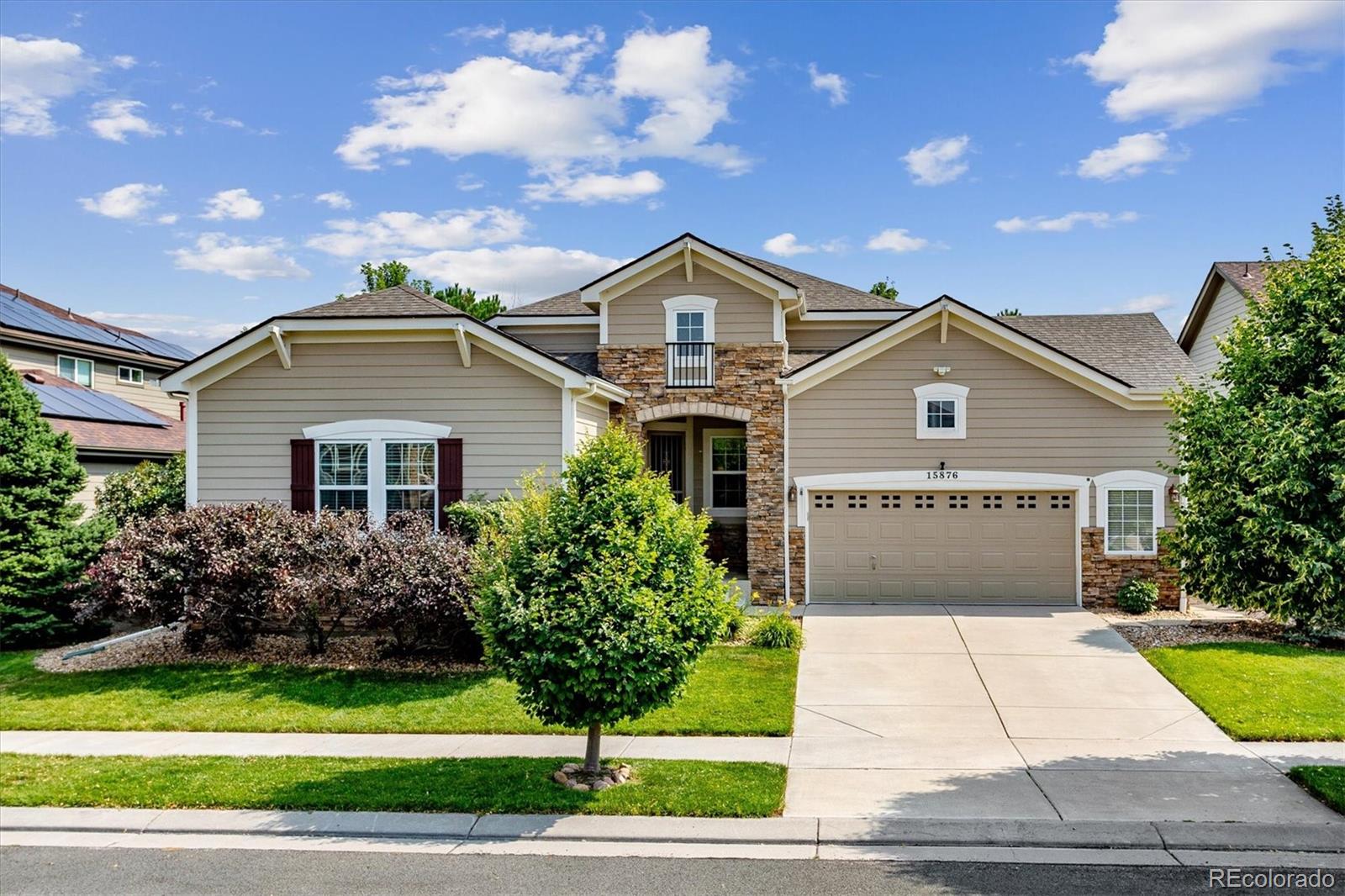 a front view of a house with a yard and garage