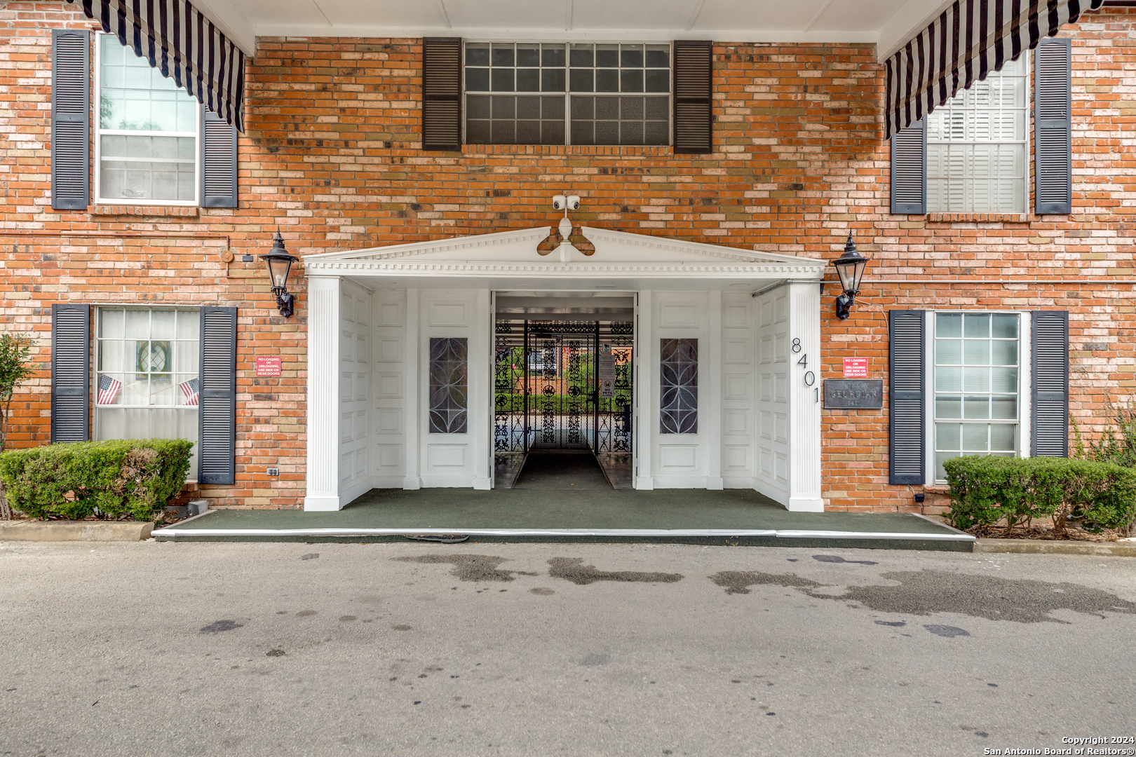 a front view of a brick house with a outdoor space