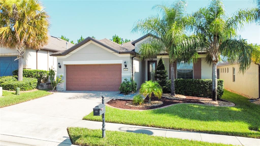 a front view of a house with a yard and garage