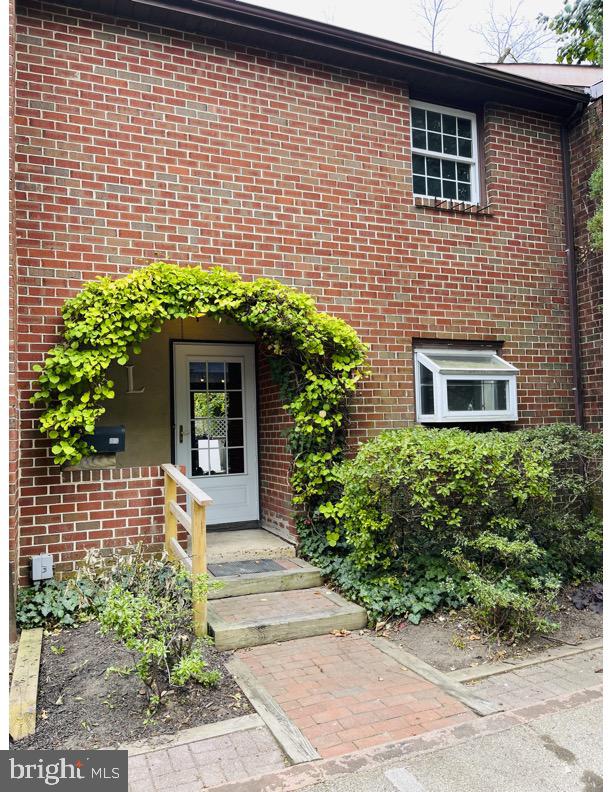 a view of a house with potted plants