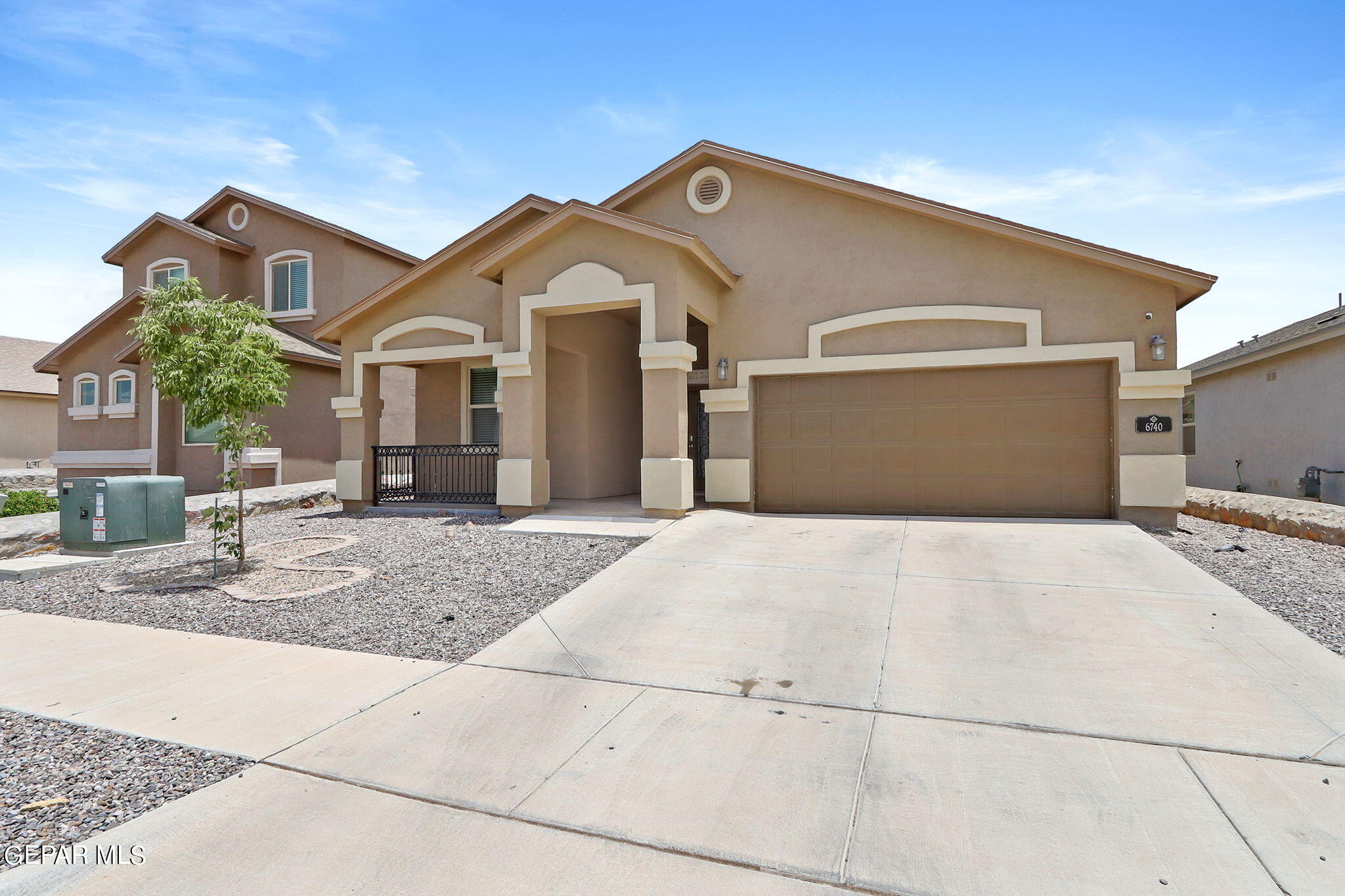 a front view of a house with garage