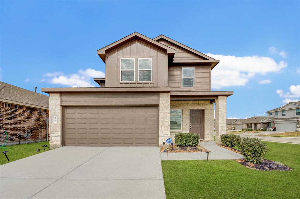 a front view of a house with a yard and garage