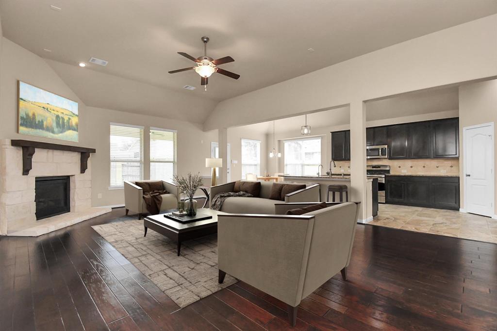 a living room with furniture a fireplace and a flat screen tv