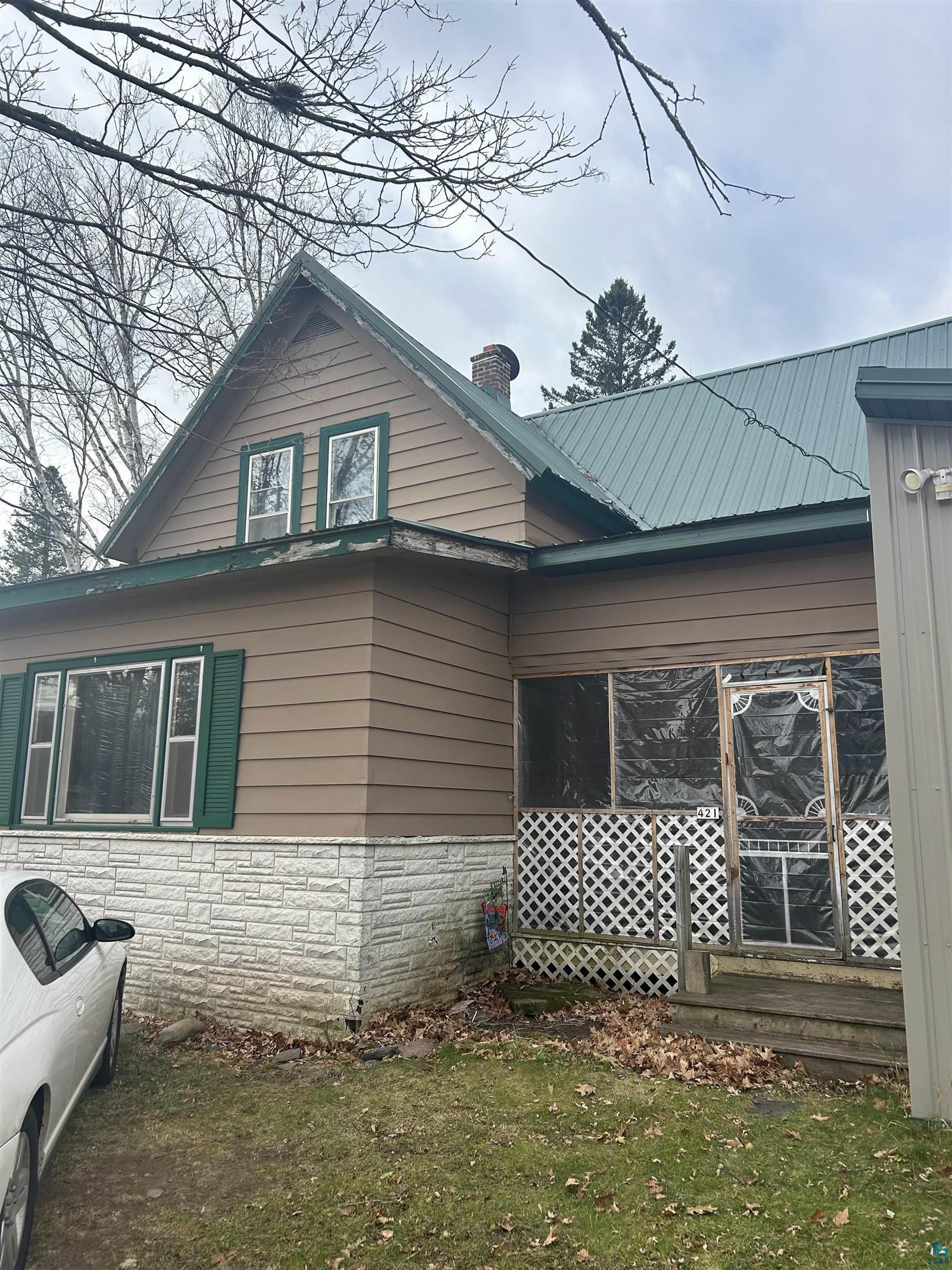 View of side of property with a lawn