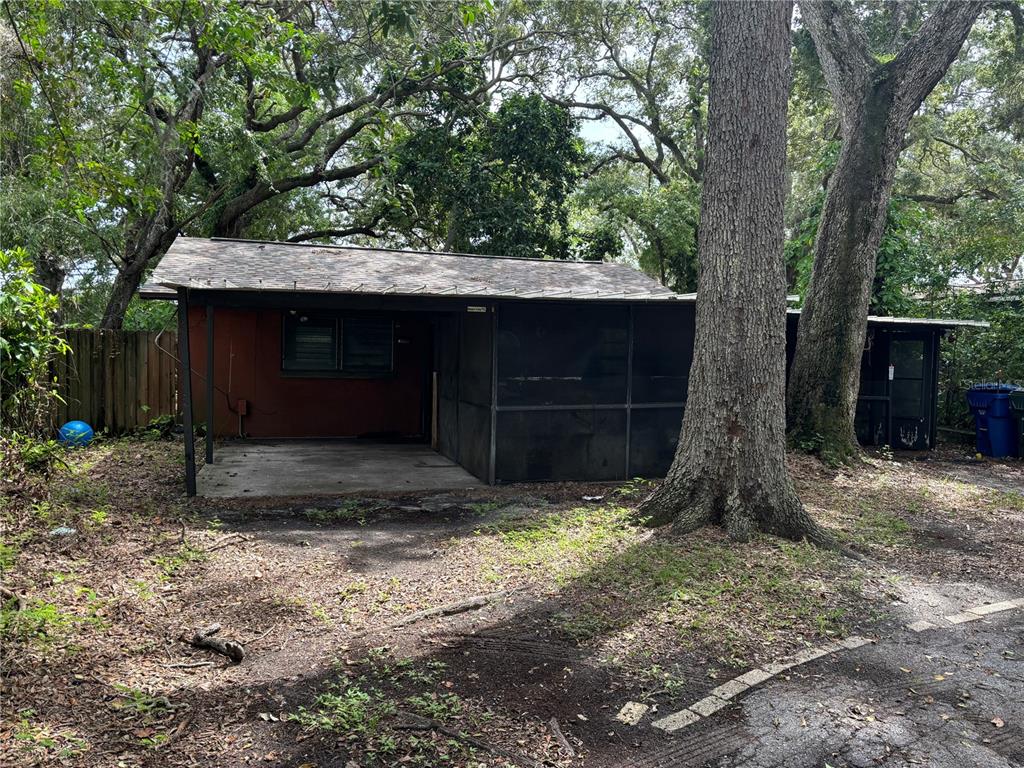 a backyard of a house with a tree