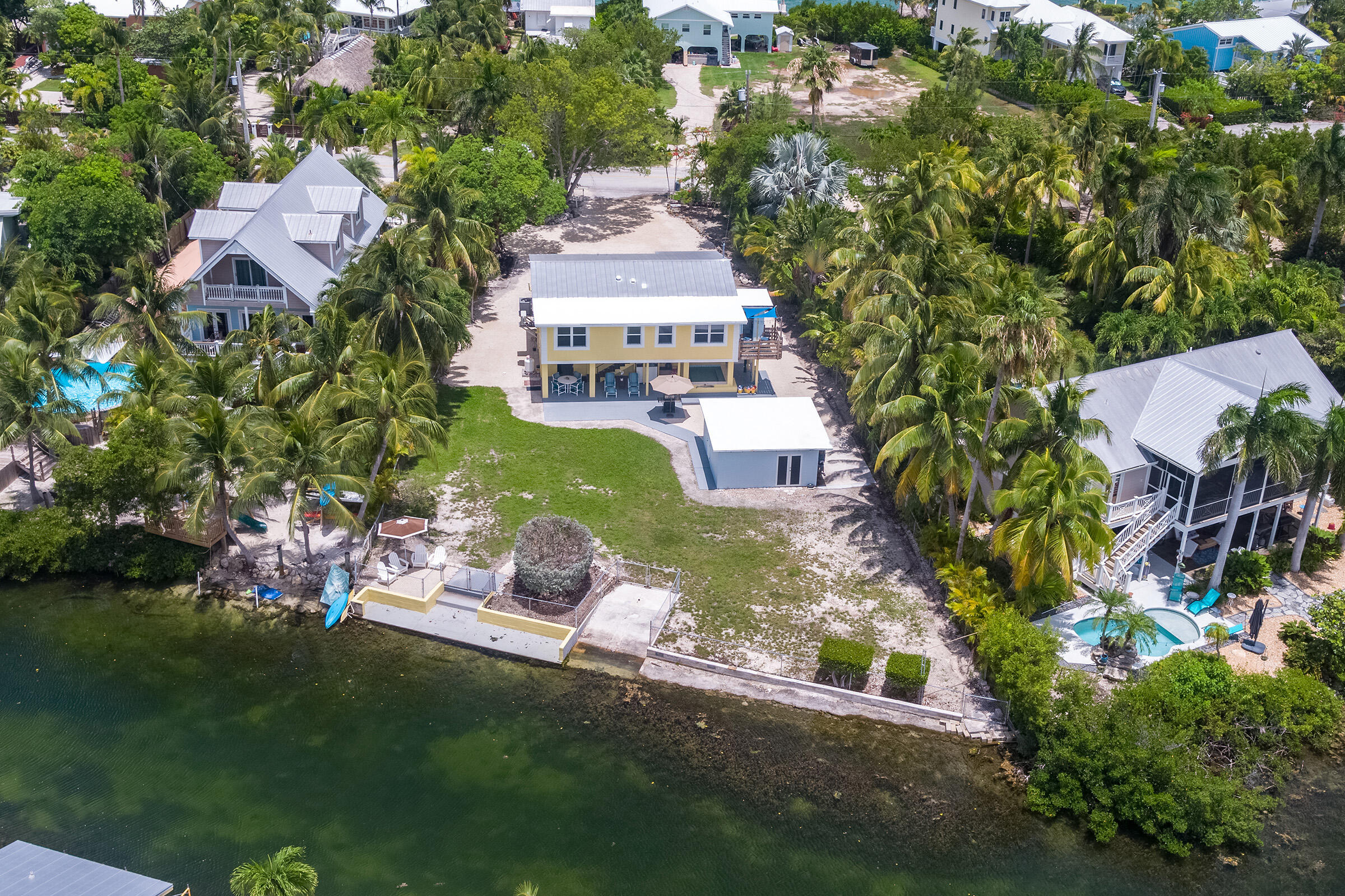 an aerial view of a house with garden space and street view