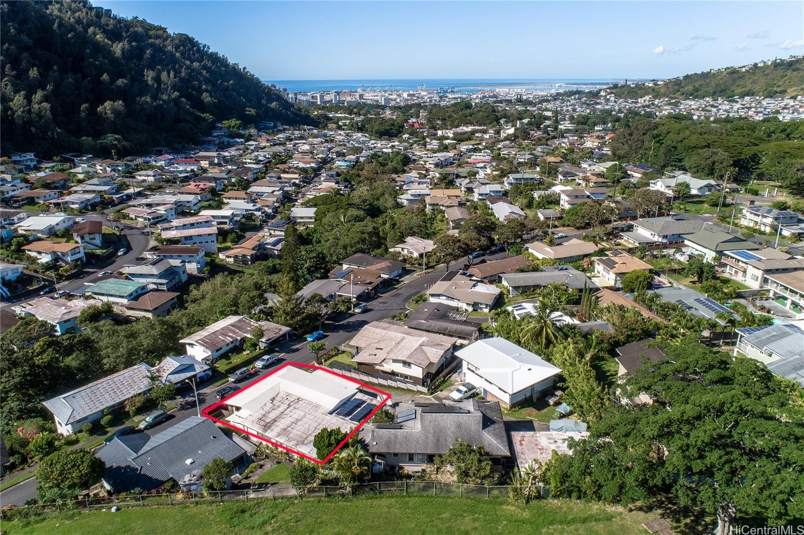 an aerial view of residential houses with outdoor space and trees