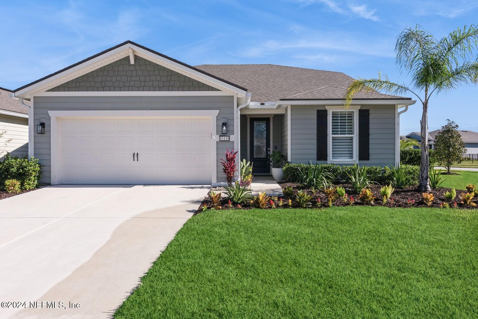 a front view of a house with a yard and garage