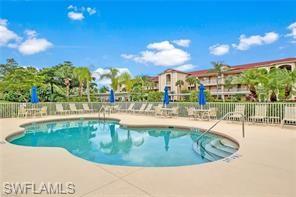 a view of a swimming pool with an outdoor seating