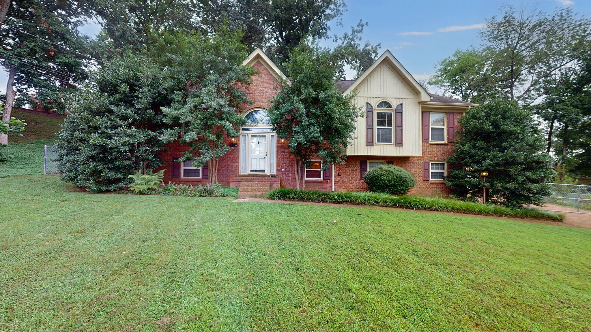 a front view of a house with garden