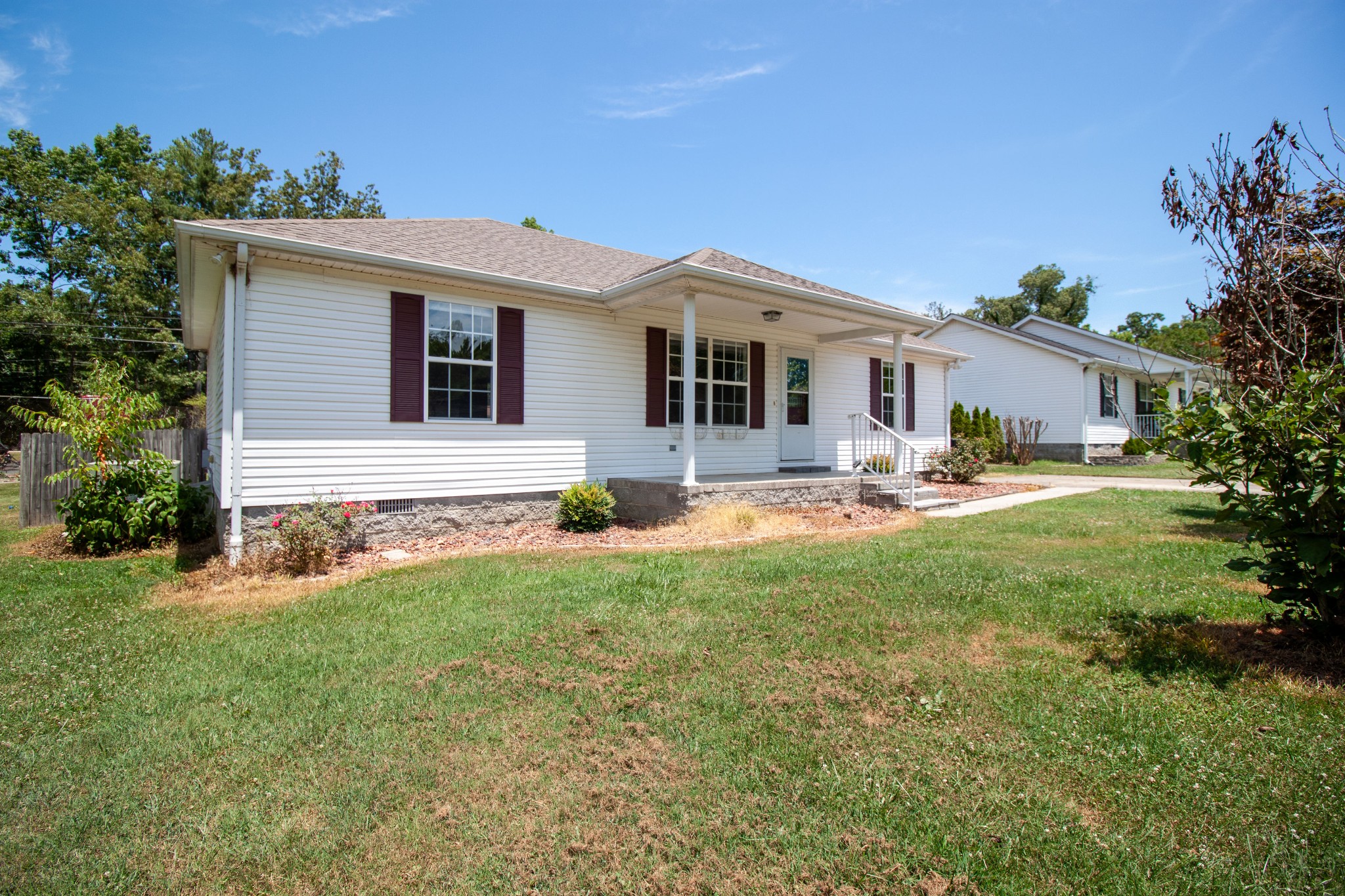 a front view of house with yard and green space