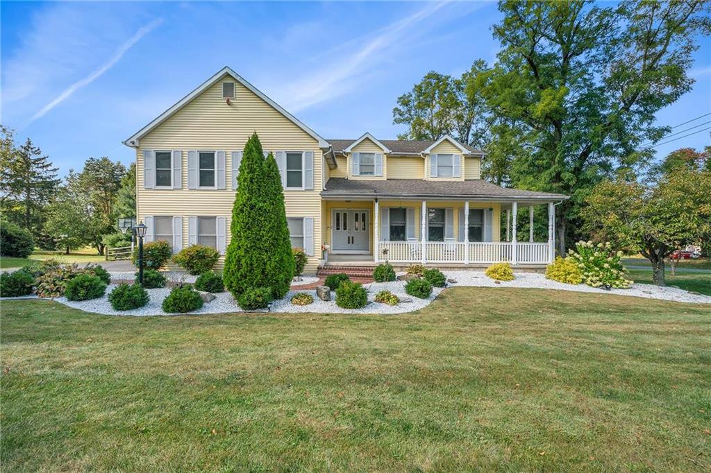 a front view of a house with yard and green space