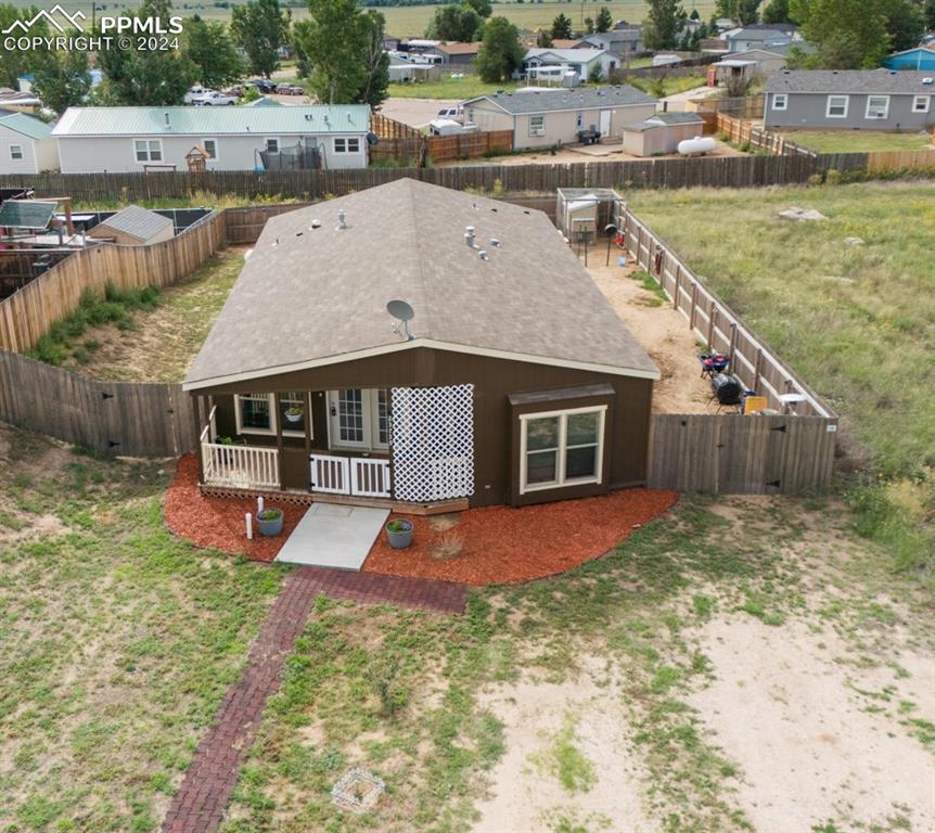 a view of a house with backyard and sitting area