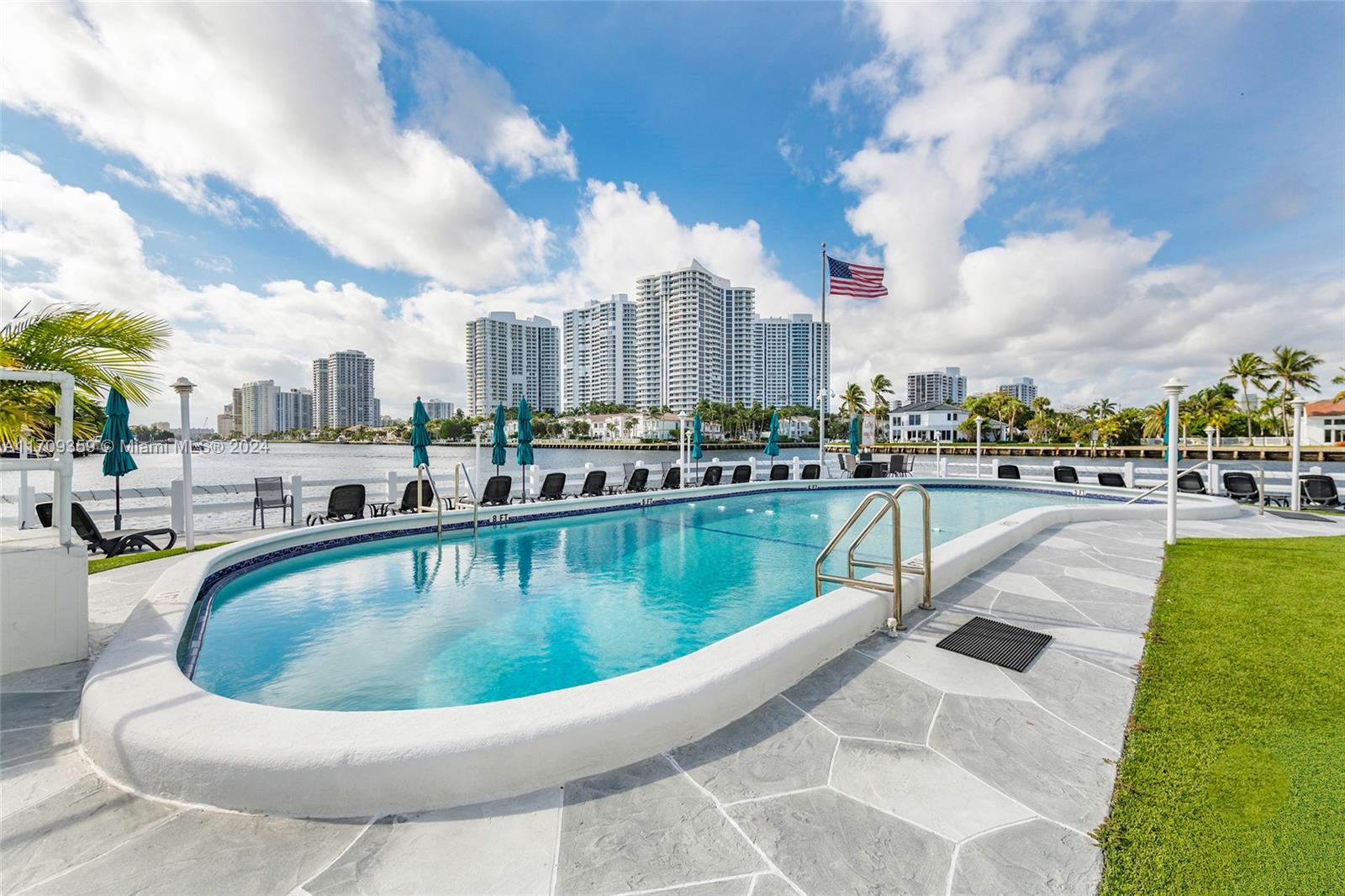 a view of swimming pool that has lawn chairs