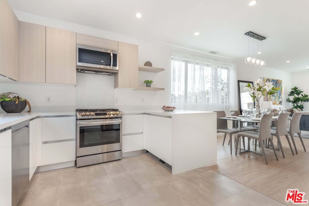 a kitchen with a stove and white cabinets