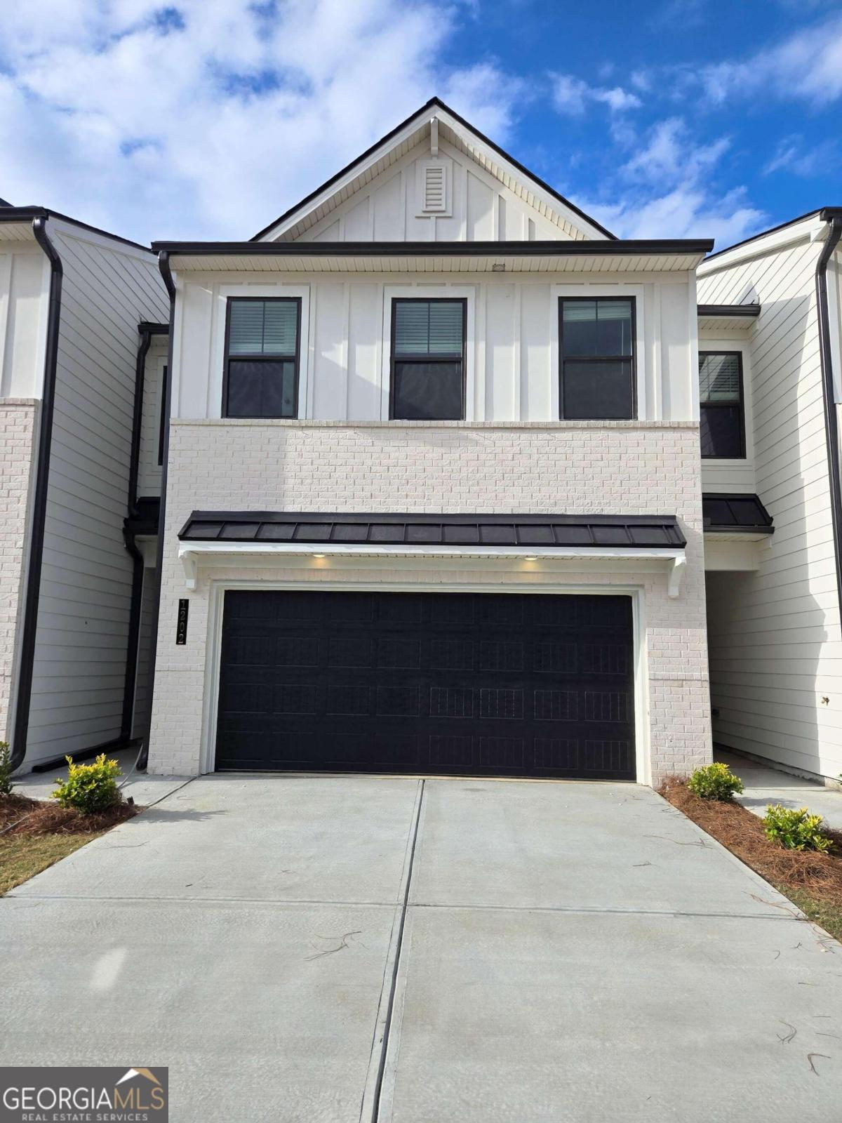 a front view of a house with a garage