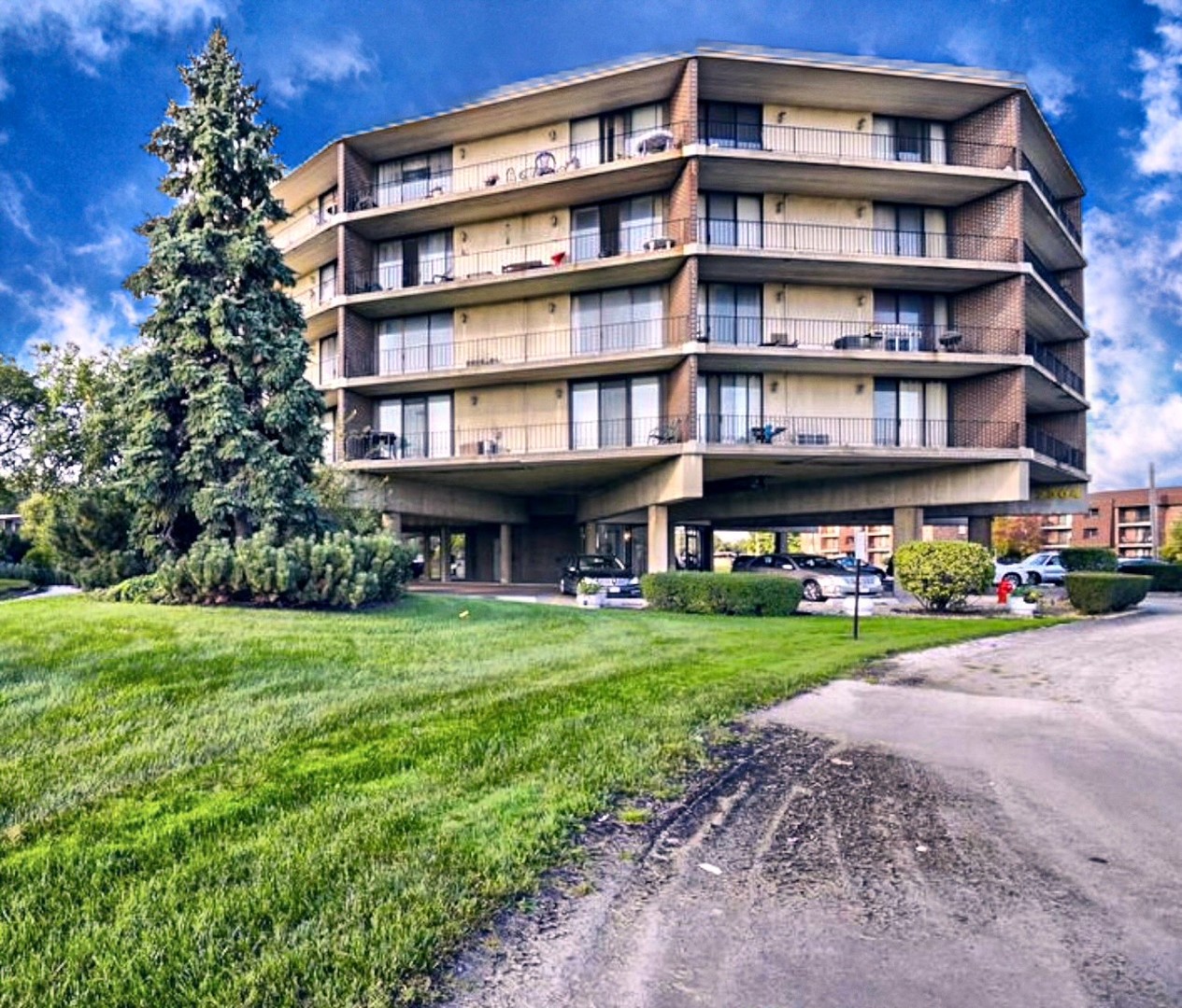 a front view of a building with a garden