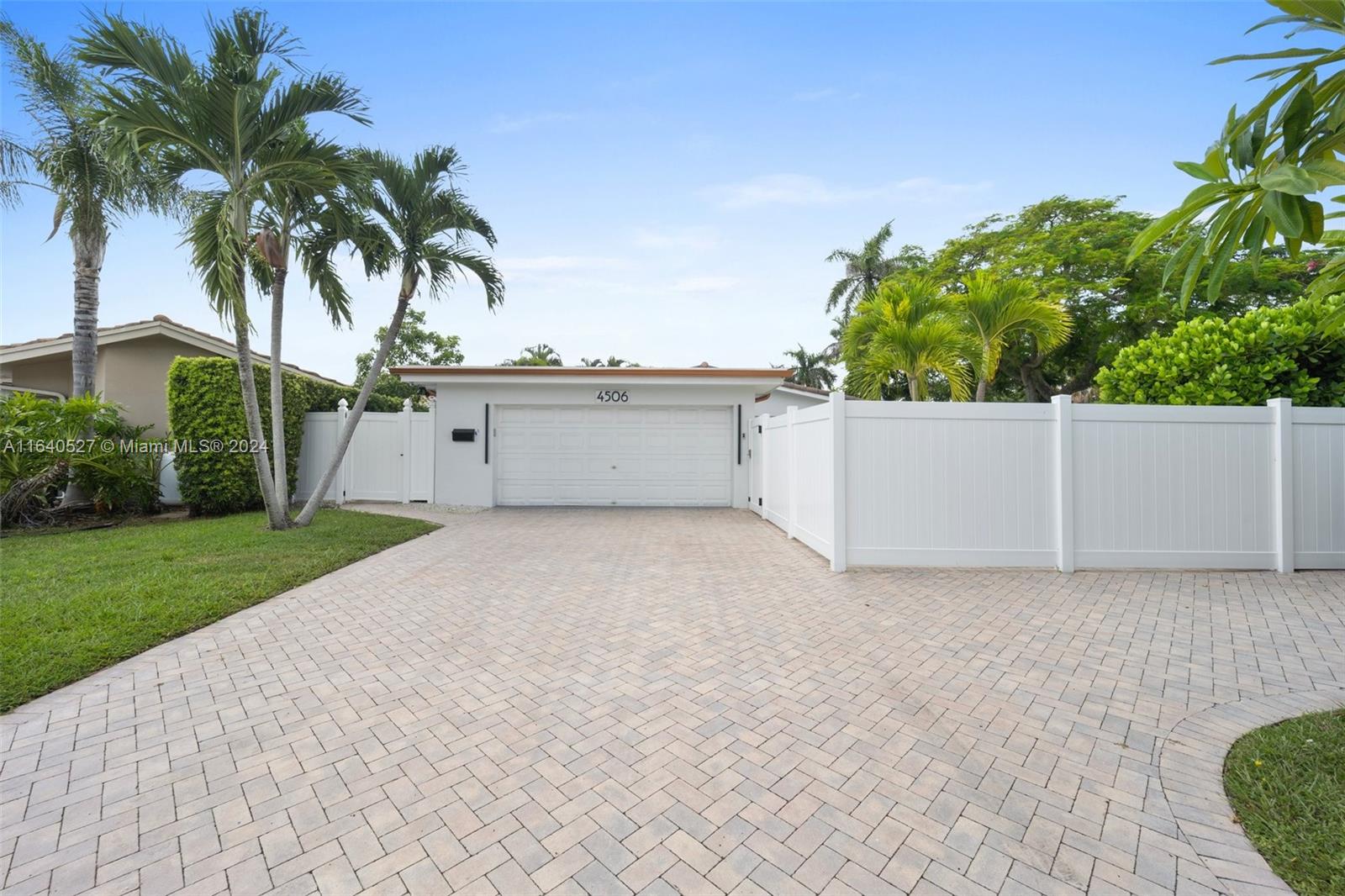 front view of house with a yard and trees