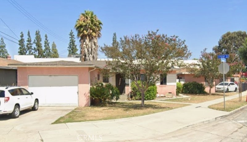 a view of a house with a cars park side of a road